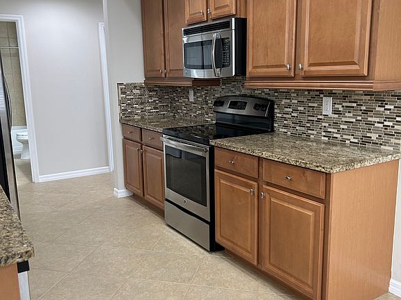 Kitchen has lot of cabinuts.
