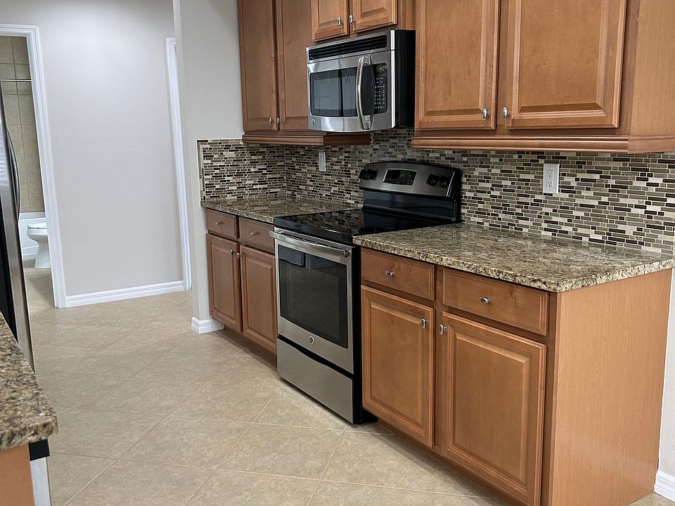 Kitchen has lot of cabinuts.