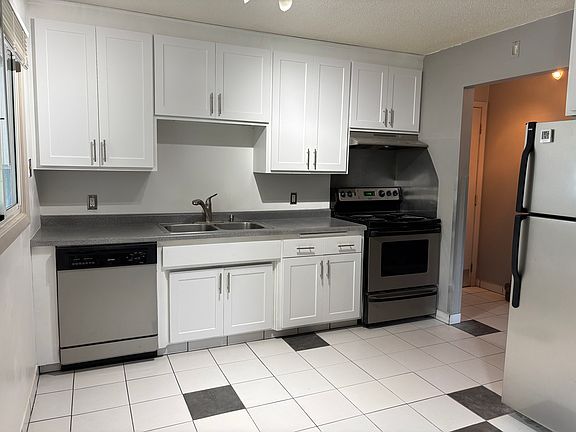 Stainless steel appliances include dishwasher, disposal, electric oven and stove, direct to exterior venting range hood.