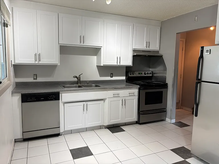 Stainless steel appliances include dishwasher, disposal, electric oven and stove, direct to exterior venting range hood.