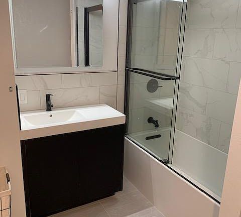 Newly renovated bathroom with bathtub and shower