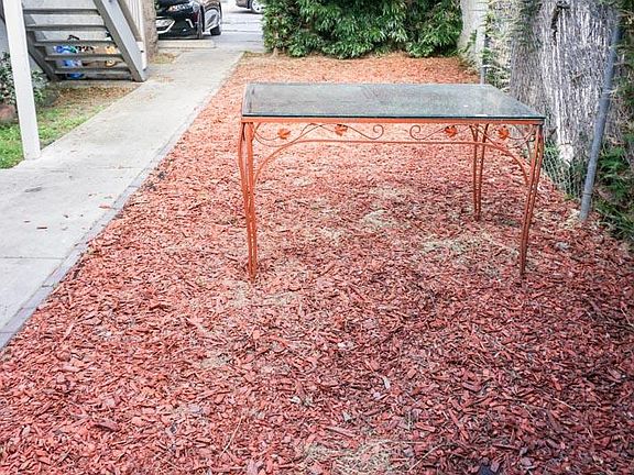 Side garden - communal use for 907A & B. Gated parking area in background