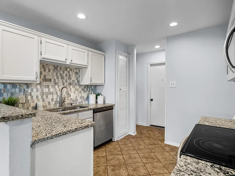 The kitchen has granite counters and a modern backsplash.