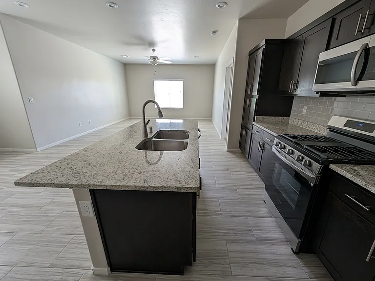Great counter space and breakfast bar with the kitchen island.