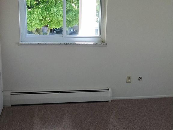 Bedroom with new carpet and window treatments