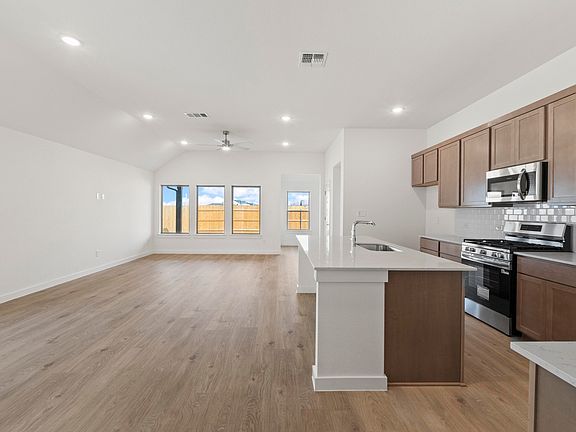 Kitchen in the Quartz home plan by Trophy Signature Homes - REPRESENTATIVE PHOTO
