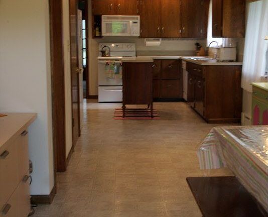 Kitchen extends into an oversized dining area with lots of windows.