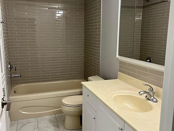Bathroom with soaker tub and built in linen closet.