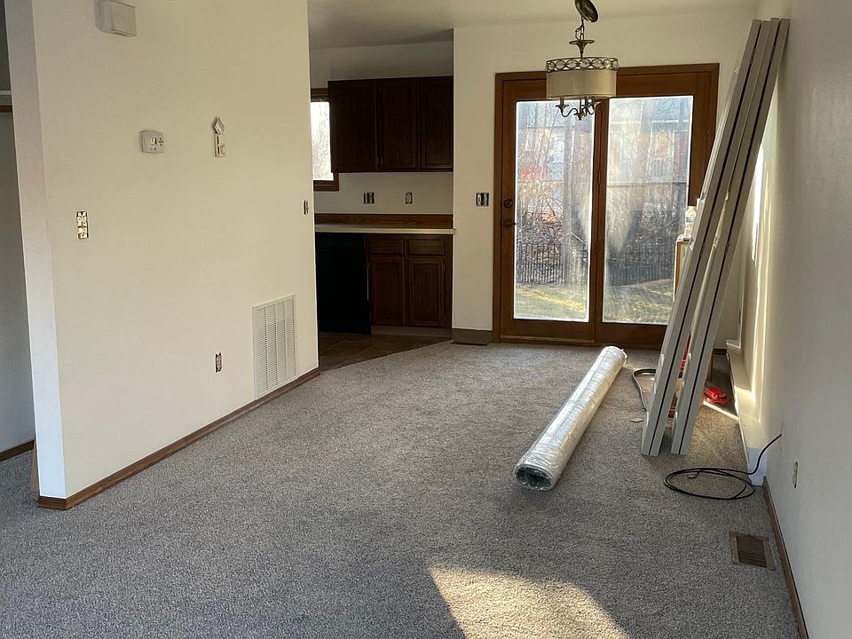 Open living room/dining room space leads to the back porch