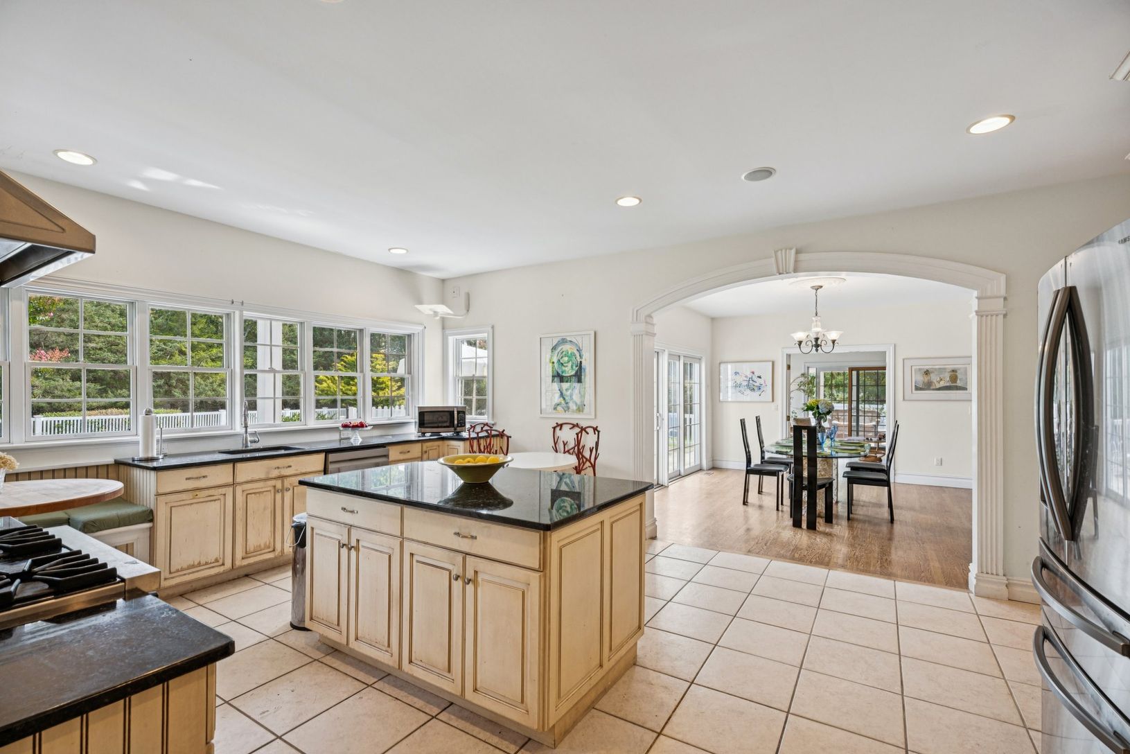 An alternative view of the kitch, featuring an eat-in dining area, recessed lighting, tile flooring.