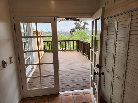 French doors leading to private deck expand living space and add character.