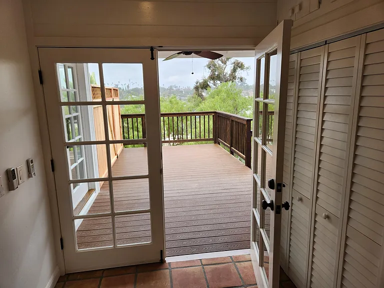 French doors leading to private deck expand living space and add character.