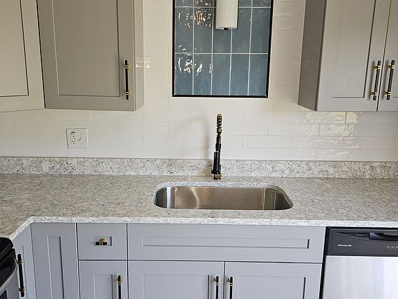 Custom backsplash, Granite countertops, new cabinets, undermount sink, and stainless-steel appliances.