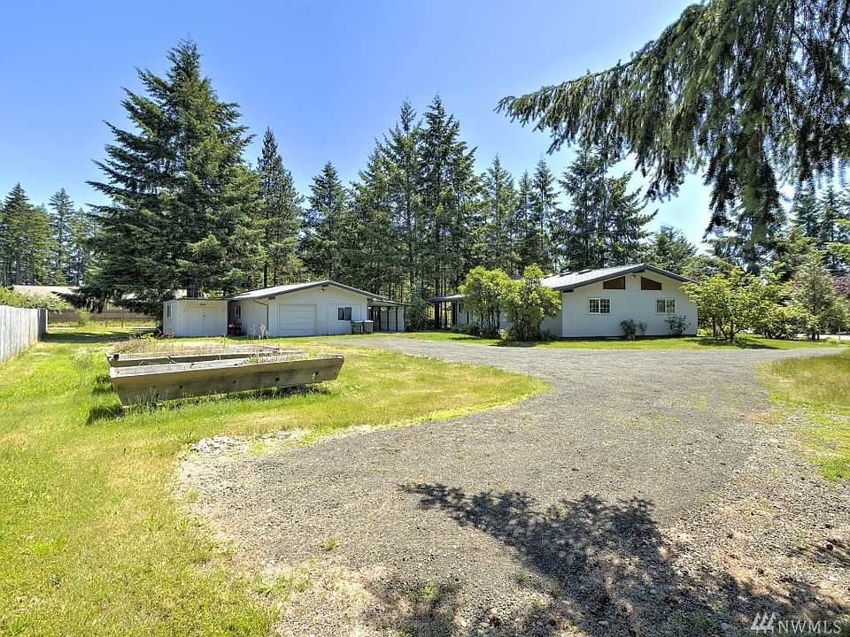 Big 3/4-acre parcel with a nice house AND a separate shop that has a kitchen, bath, and office. Notice the raised garden beds in the forefront...