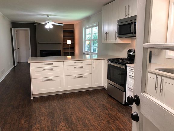Recently renovated kitchen has granite countertops, stainles