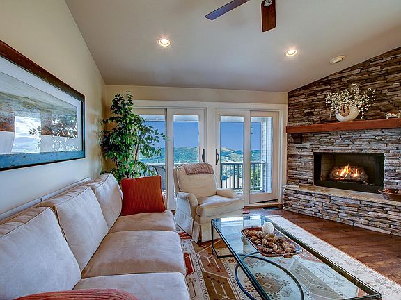 Family room has a gas log fireplace, access to the covered deck with unbelievable views and volume ceilings.