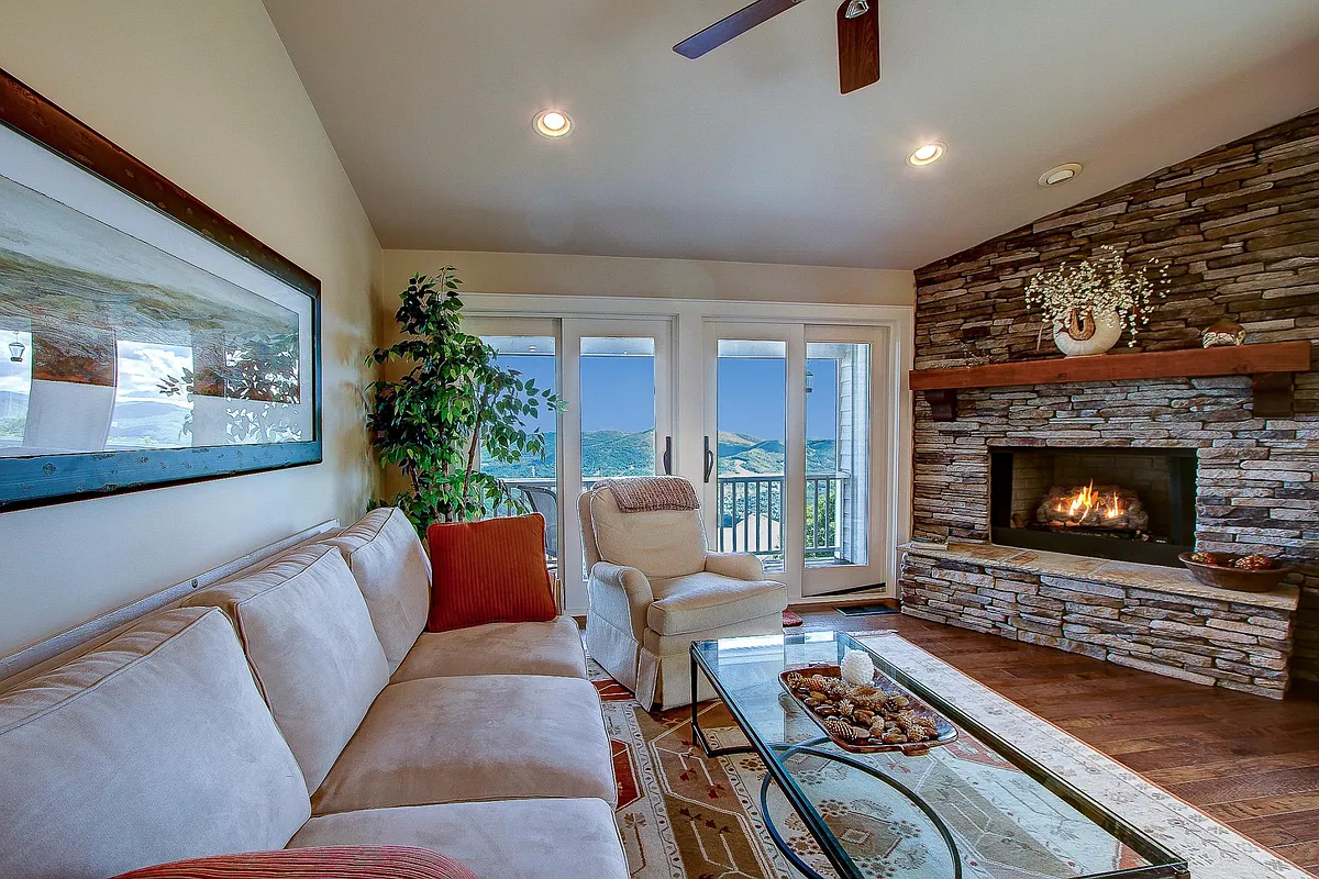 Family room has a gas log fireplace, access to the covered deck with unbelievable views and volume ceilings. - 510 Elderberry Ridge Rd #D3