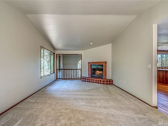 A warm fireplace corners the room. 