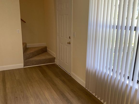 Living room leading to steps going upstairs