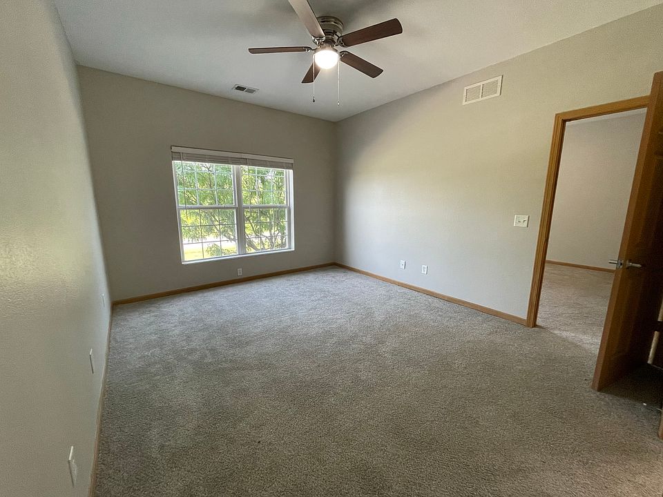 Spacious master bedroom with ceiling fan and window