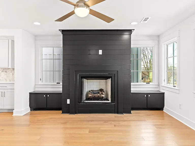 living room area, remote controlled gas fire place, white plate covers have been replaced with black covers