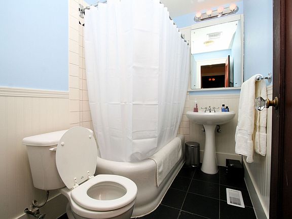Bathroom with slate flooring and wainscoting