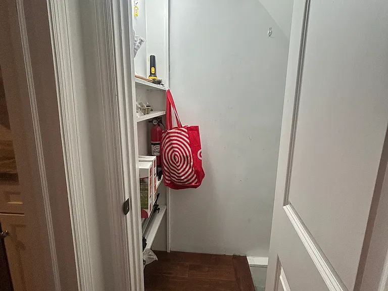 entryway to basement - extra shelving on entry wall there to left