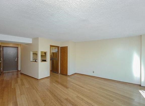 Vacant room photo of main dining room, living room, looking into kitchen