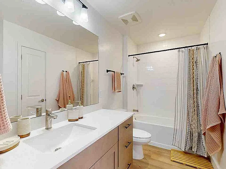 Step into this elegant bathroom oasis featuring contemporary design and soothing light.