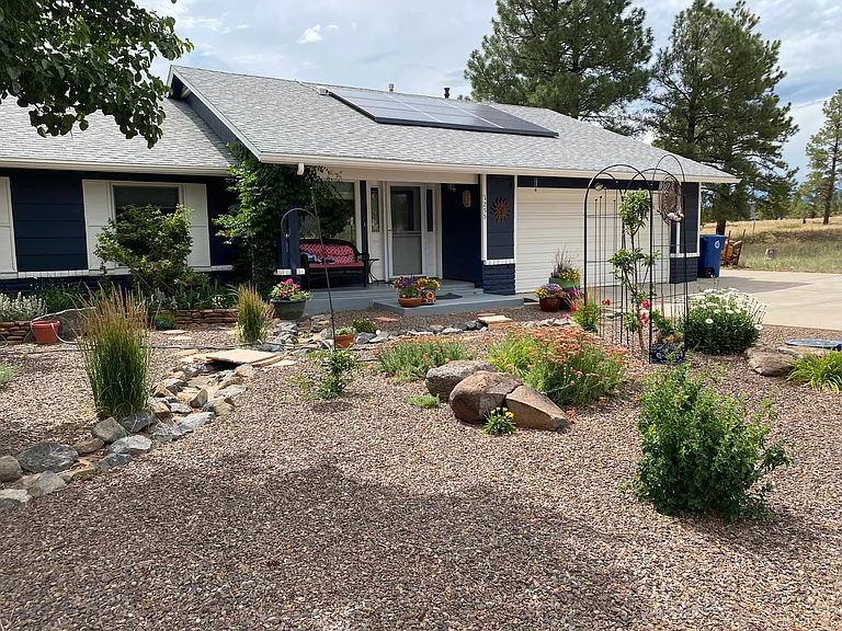 Front of house on the end of the street, open space on two sides.