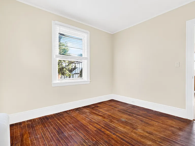 Bedroom with hardwood floors.