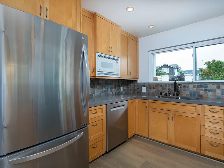 Our fully equipped kitchen also features all new wood flooring!