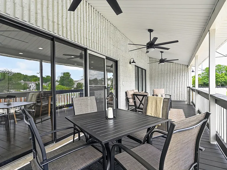 Enjoy outdoor living on your private patio featuring a table and chairs at Renaissance at Carol Stream in Carol Stream, IL.