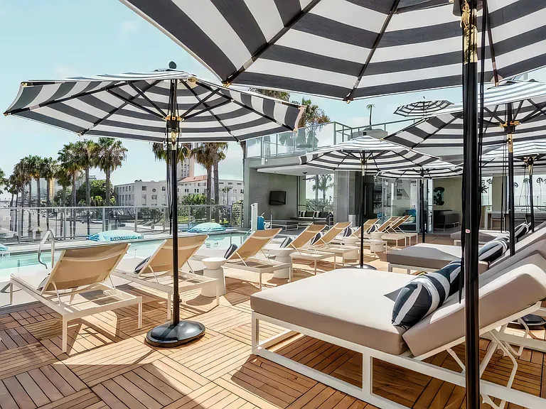 Relaxing Poolside Lounge Area with Daybeds and Outdoor Seating