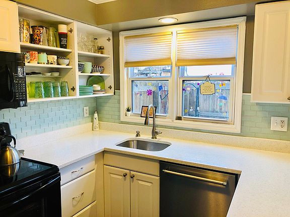 New kitchen countertops and new fridge, dishwasher, lighting. The glass subway tile and quartz countertops give the kitchen a clean, cheery look and feel.