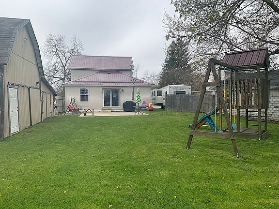 Rear view of house w/ yard