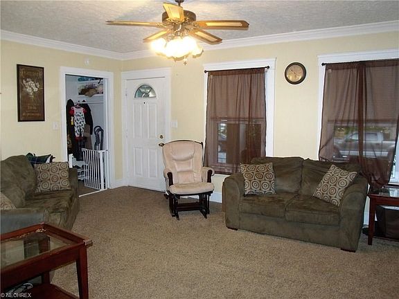 Alternate view of the living room.  When in the home, notice the newer windows throughout the home. Please note that the pets have damaged the mini blinds here and in the dining room, but they will be replaced when the sellers move out.