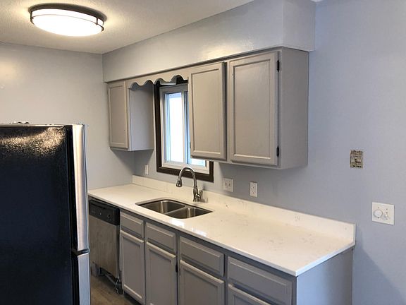 Dishwasher next to double sink.