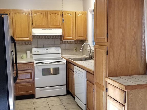 Kitchen with large side by side refrigerator, pantry, and lots of cabinets!