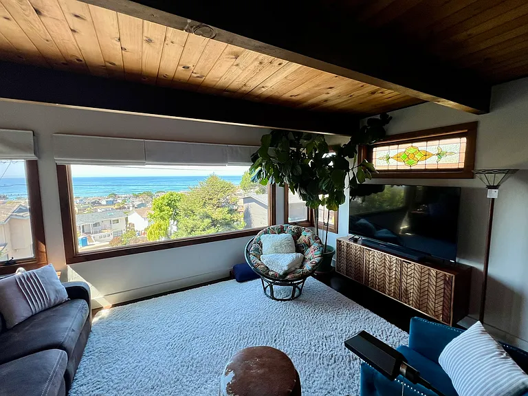 Living room with stunning ocean view, papasan chair to curl up in