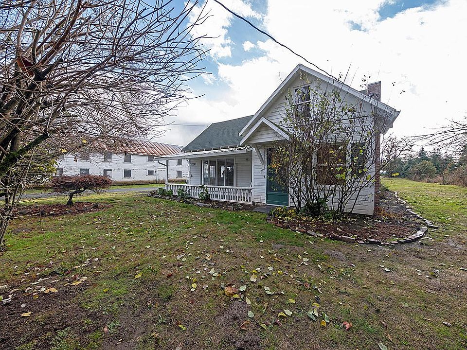 One and a half story cottage on a working farm. Very private. Secluded garden. This house faces North and has a covered front porch to the left.