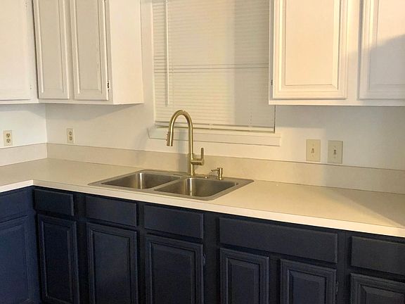 Kitchen: navy lower cabinets, white upper, upgraded gold faucet.