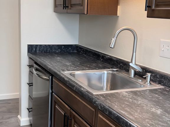 Brand new counter tops, cabinets, sink and faucet, plus matching wood floors.