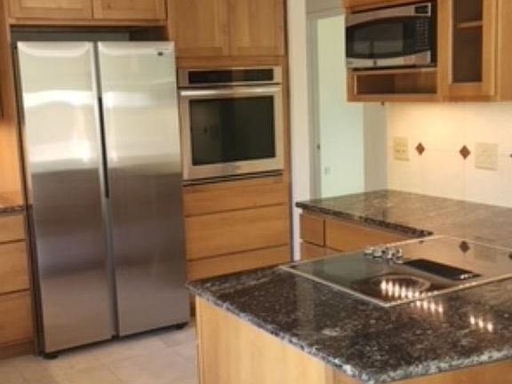 High end stainless appliances new refrigerator with icemaker, new dishwasher, disposal and tile heated kitchen floor, microwave, downdraft vented cook top
