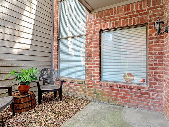 The TH Front Porch/Patio area is behind an iron gate which can have a lock if you desire, and shelters the front door on your immediate right past the gate The windows look out from the LR area, with blinds that can open or be raised for lots of ligh