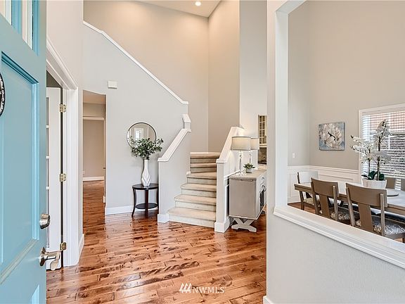 The grand entrance invites you into this beautiful home. Formal dining room on right, office to left.