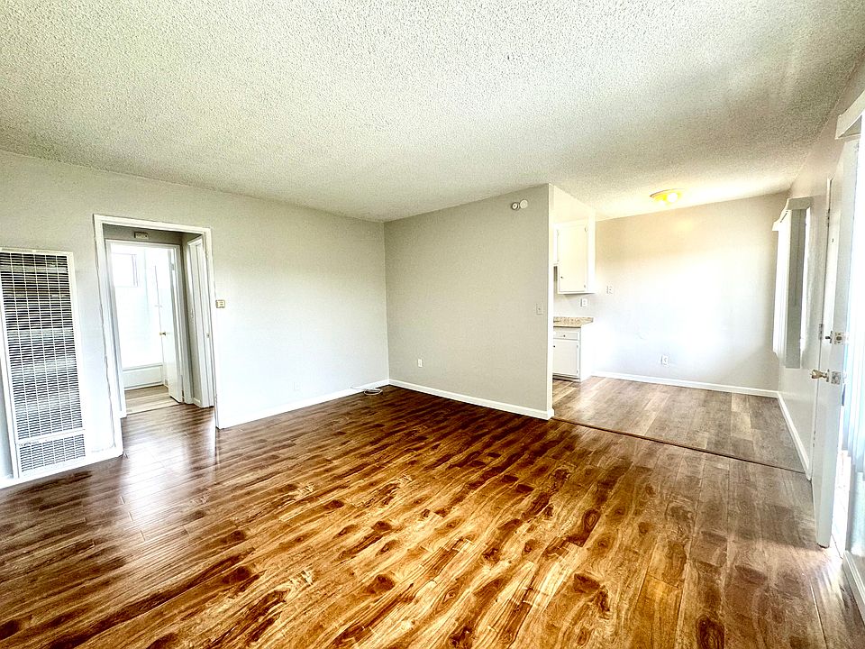 Spacious Living Room adjoins the Dining area leading to the Kitchen