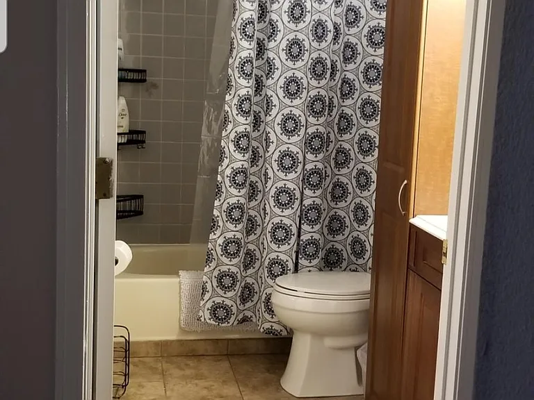 first floor bathroom. Full size washer and dryer are to the left (out of view) in a recess