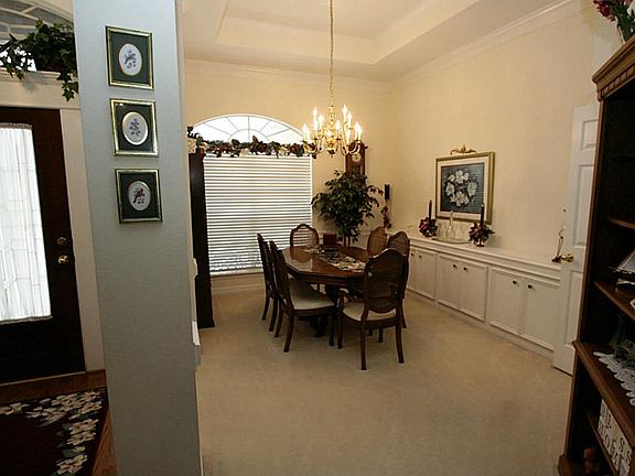 Family dinners will be a must in this beautiful dining room with it's own built in storage and serving area. Note the high ceilings and crown molding.