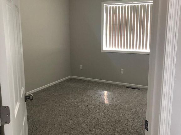 Secondary bedroom is on the main level across from the kitchen.